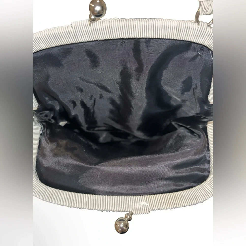 crocheted evening bag with a metal kiss-lock closure and braided shoulder strap